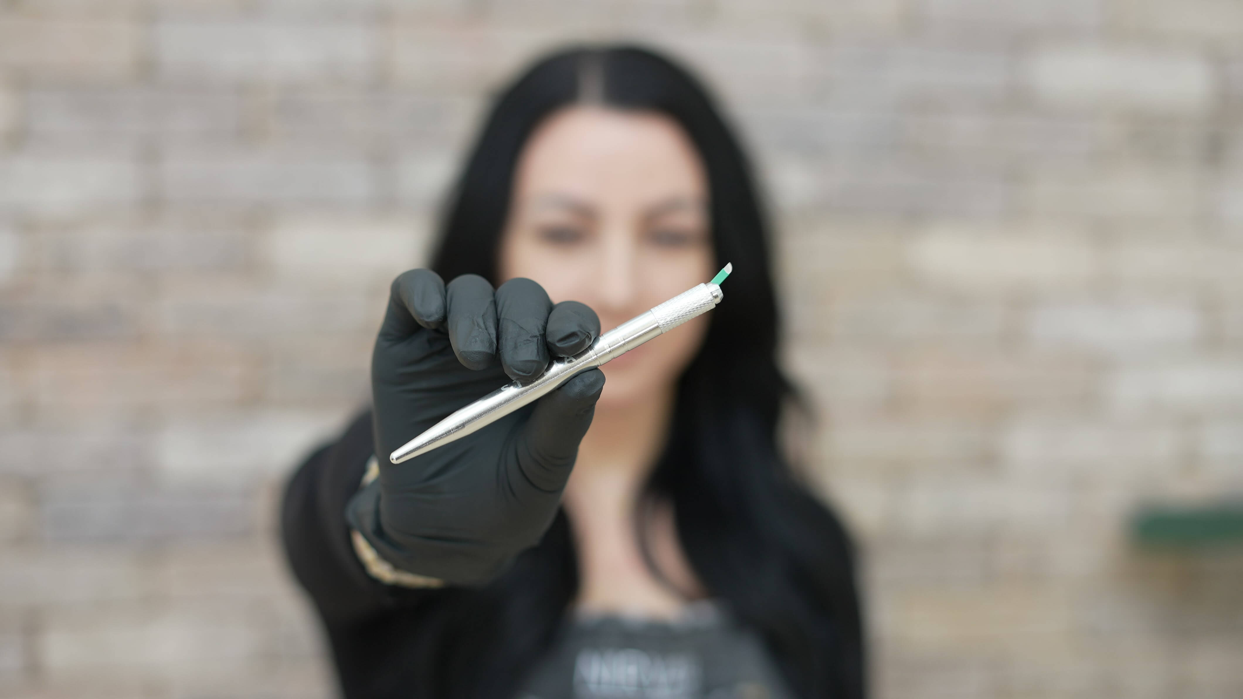 Sarah Delaney holding microblading blade